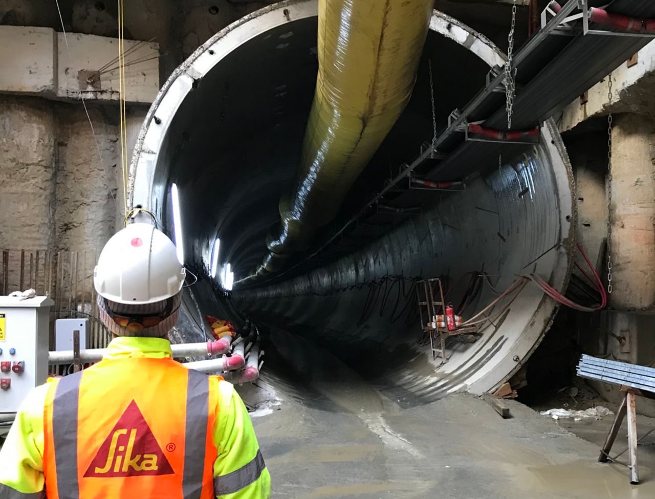 Sika engineer standing next to tunnel boring machine in tunnel construction