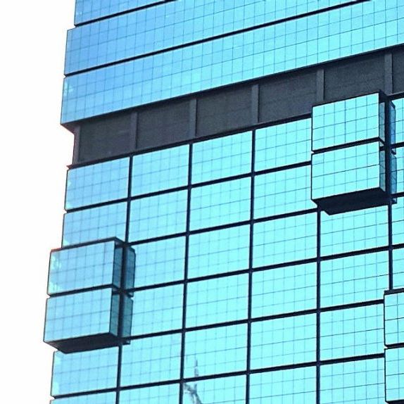 Image section of a high-rise building with glass facade