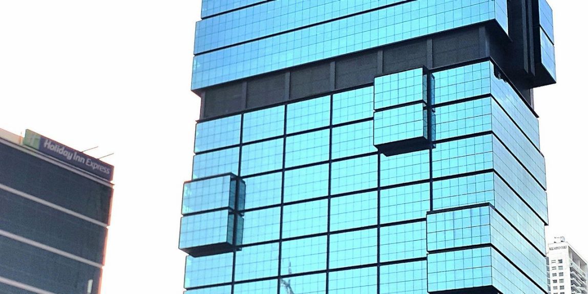 Image section of a high-rise building with glass facade