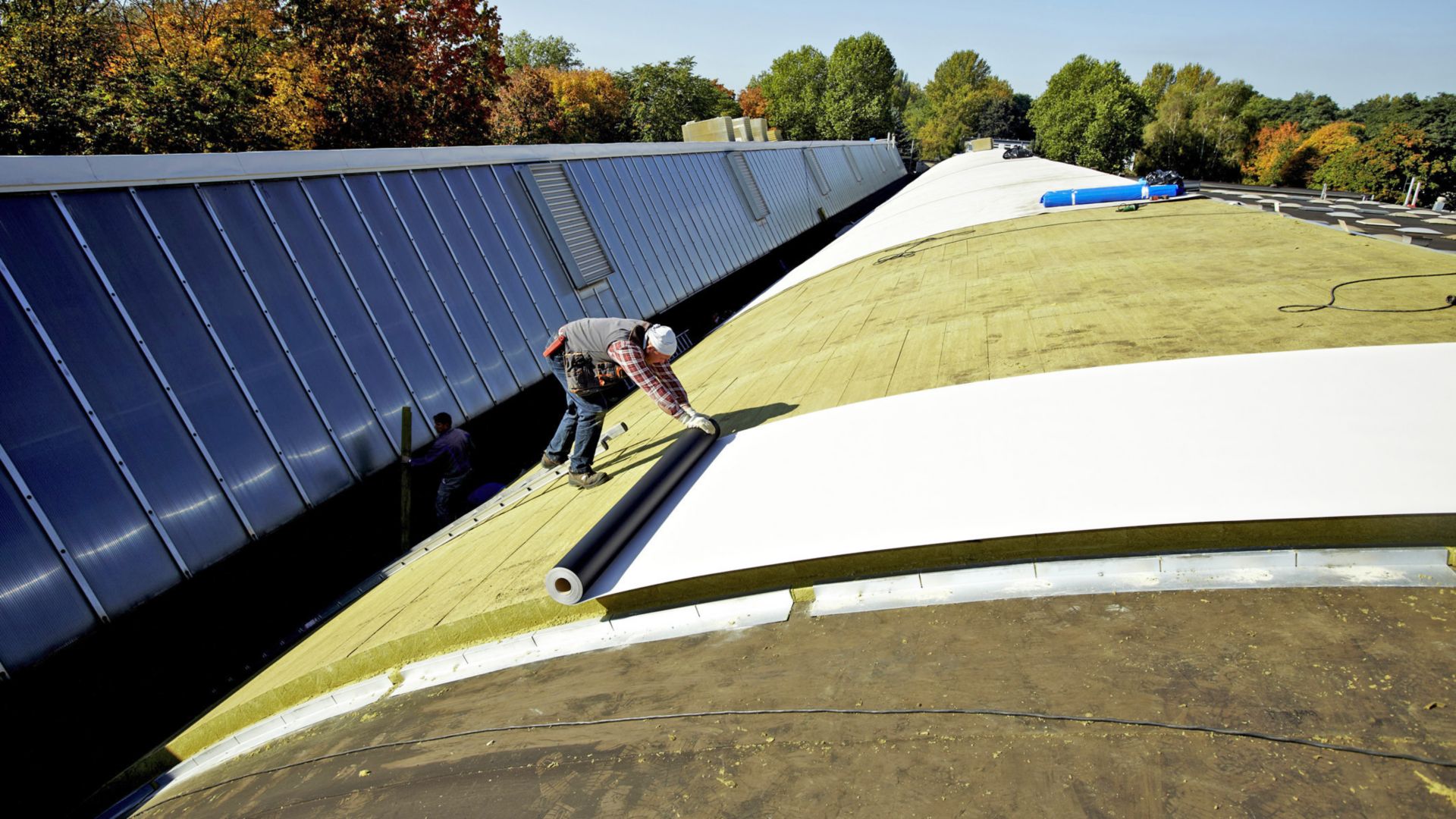 Curved shed roof renovation with Sika mechanically-fastened Sarnafil and Shedrock insulation at Volkswagen Hannover and Wolfsburg, Germany