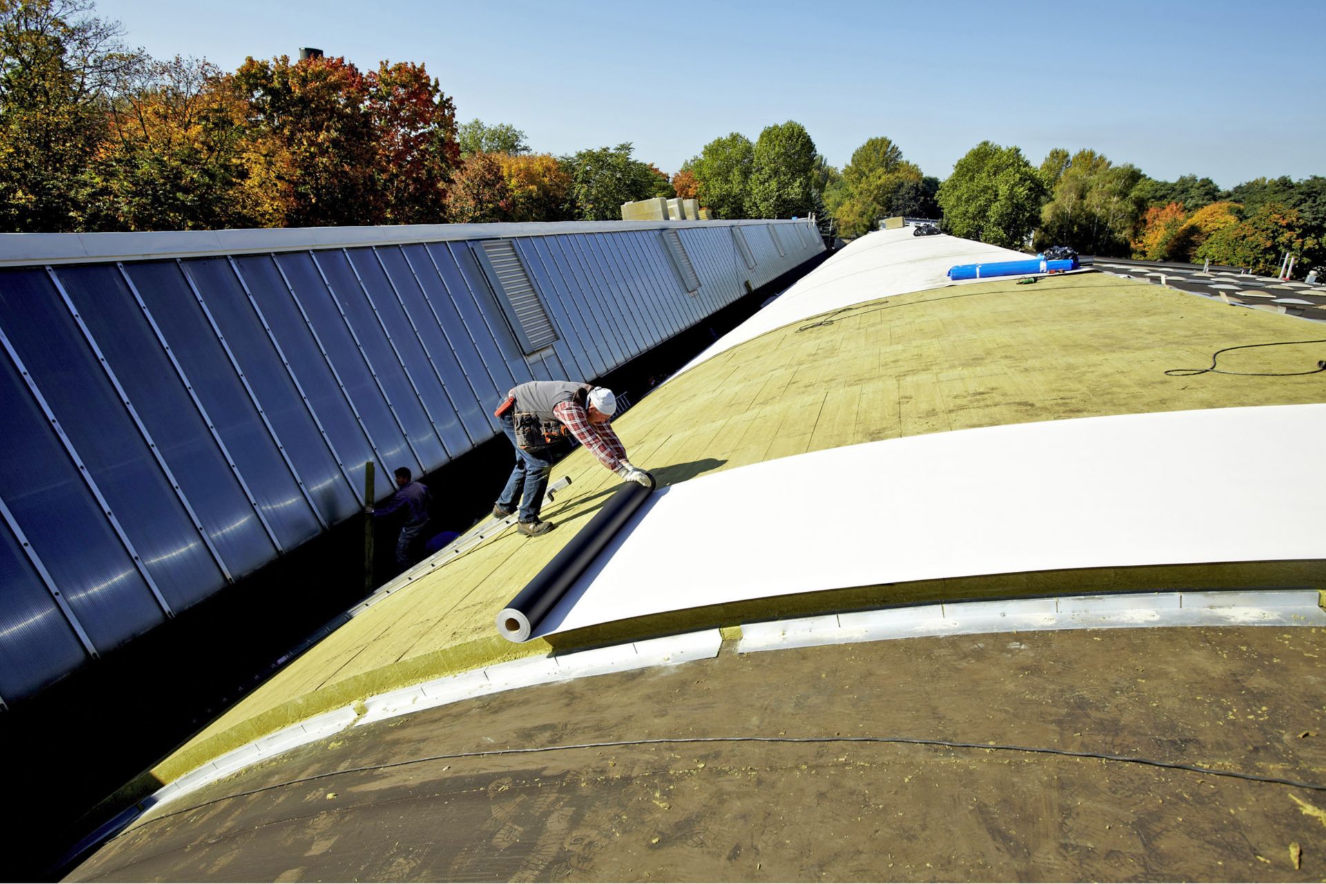 Curved shed roof renovation with Sika mechanically-fastened Sarnafil and Shedrock insulation at Volkswagen Hannover and Wolfsburg, Germany