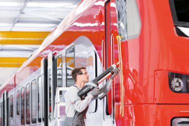 Person applying bonding a train with a powercure dispenser