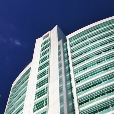 Building complex with white and green facade panel parts