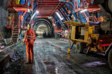 Worker at construction site inside tunnel in Vips Valley in Switzerland