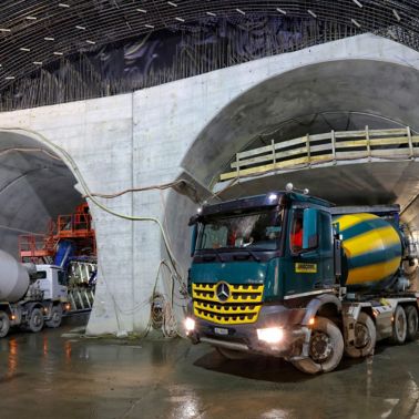 Concrete mixer trucks at construction site of Visp tunnel in Switzerland