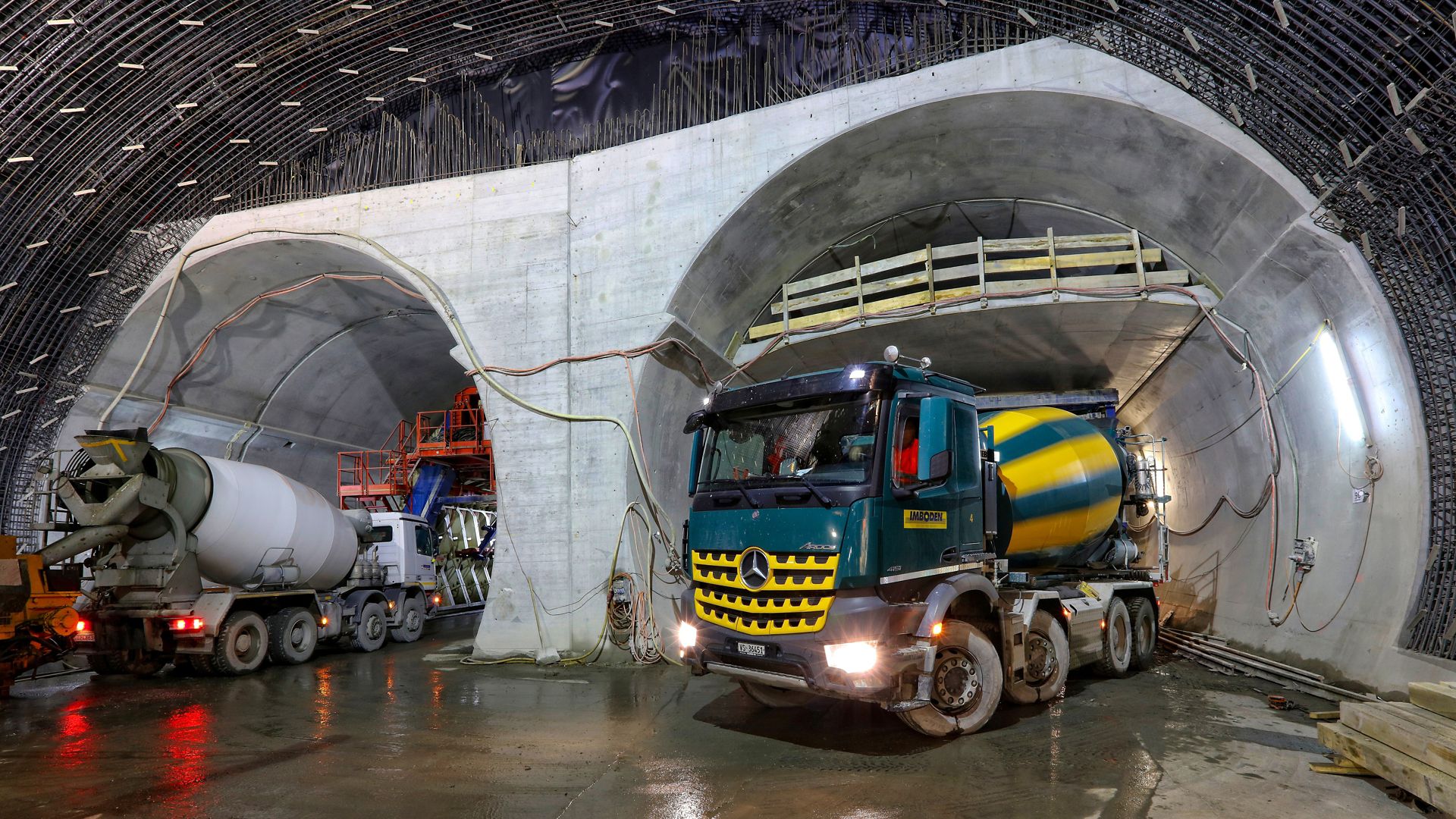 Concrete mixer trucks at construction site of Visp tunnel in Switzerland