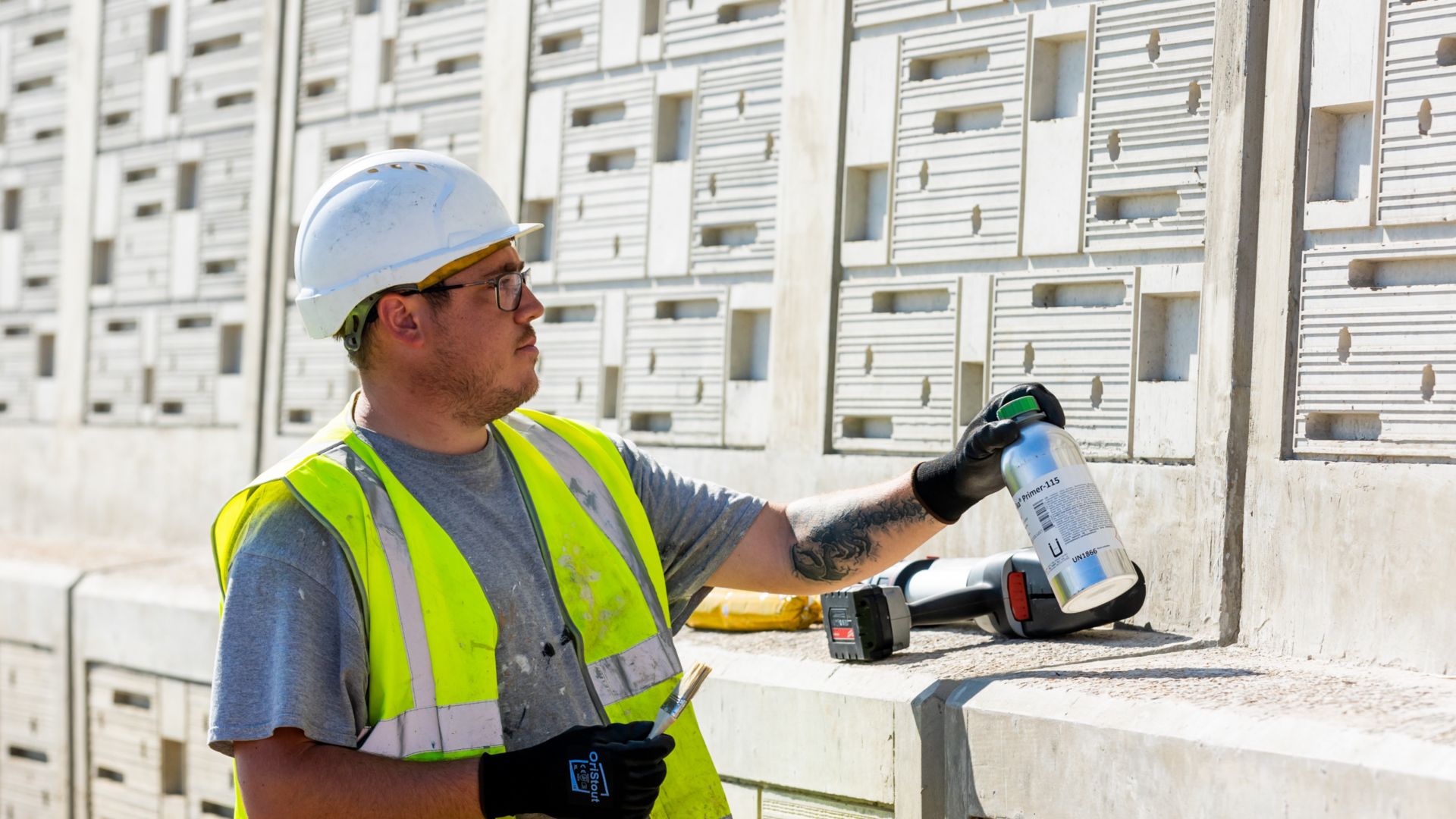 Man about to apply Sika Primer-115 onto a wall