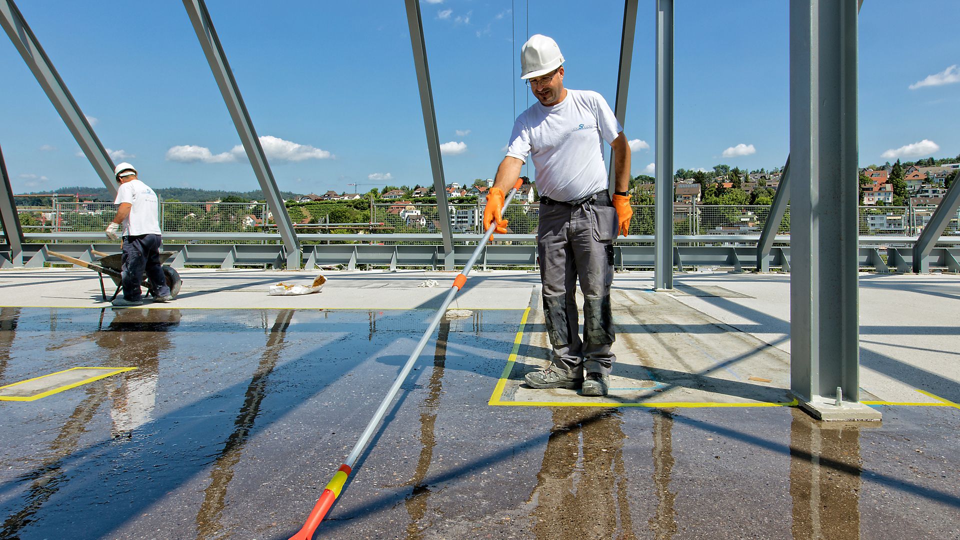 Man applying waterproof coating to concrete floor at Limmat building in Zurich