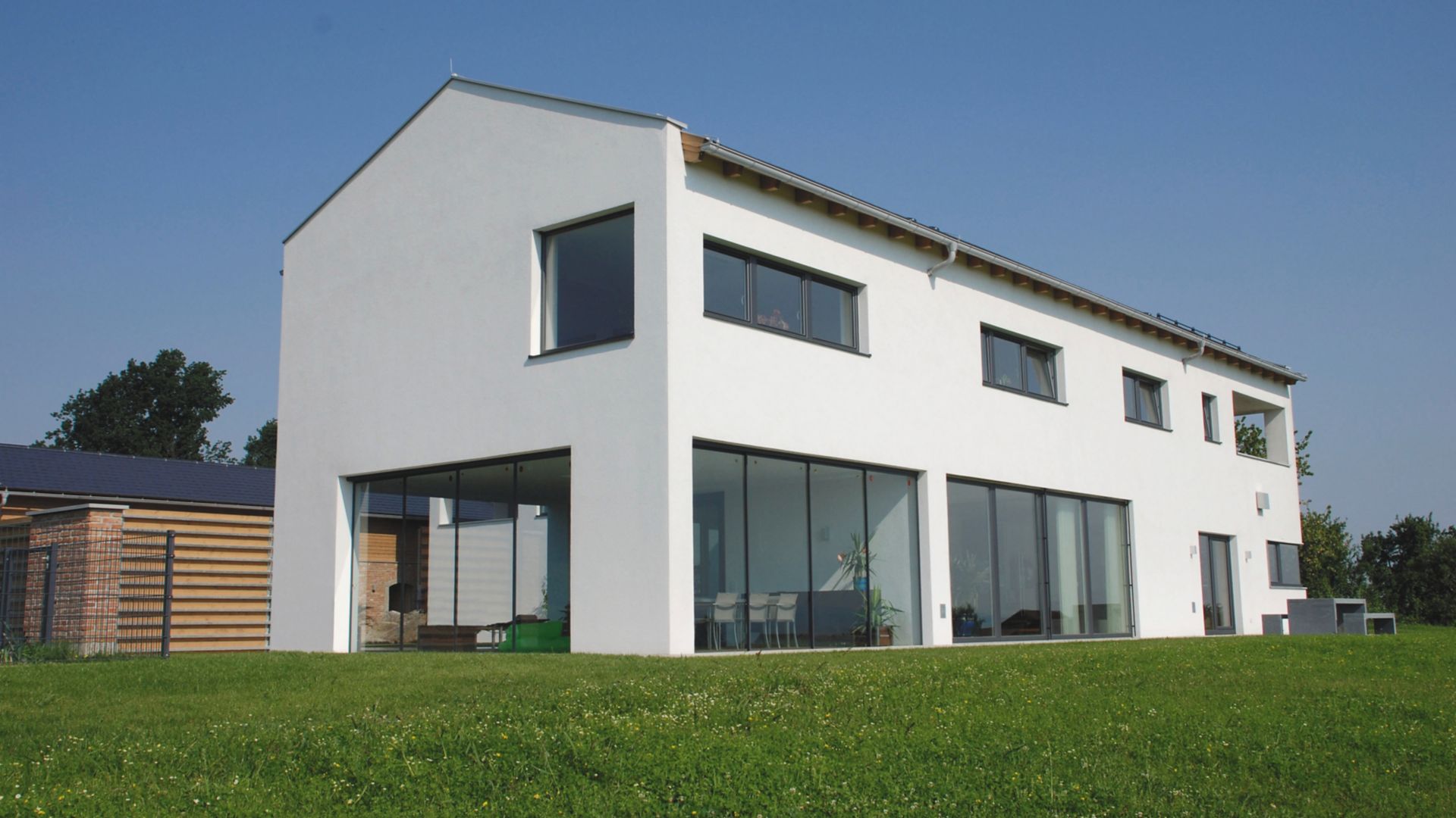 White residential building with green garden