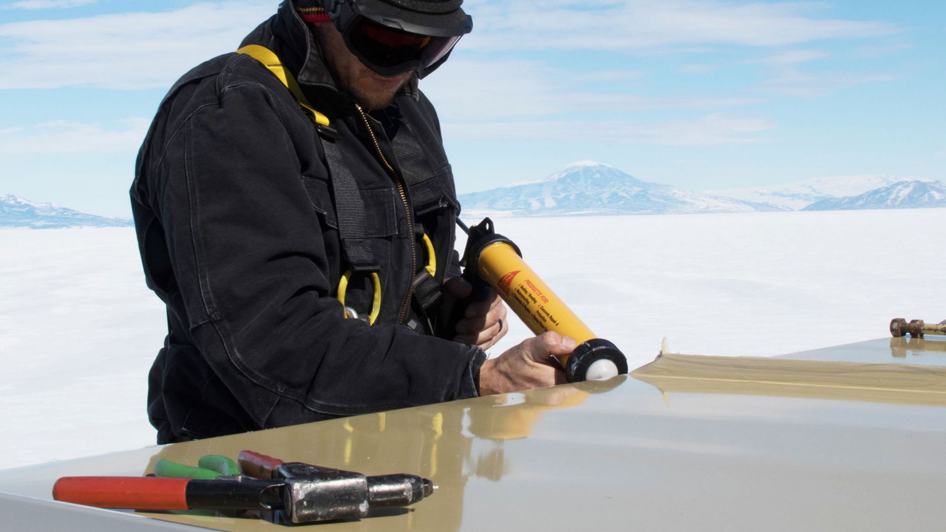 worker applying adhesive with an application gun