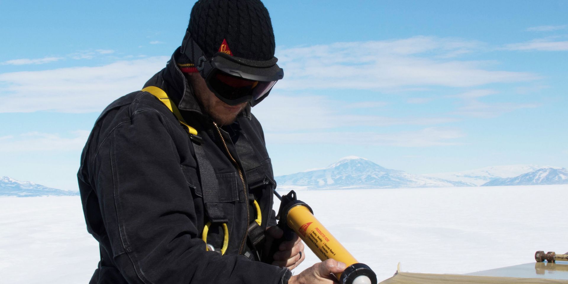 worker applying adhesive with an application gun