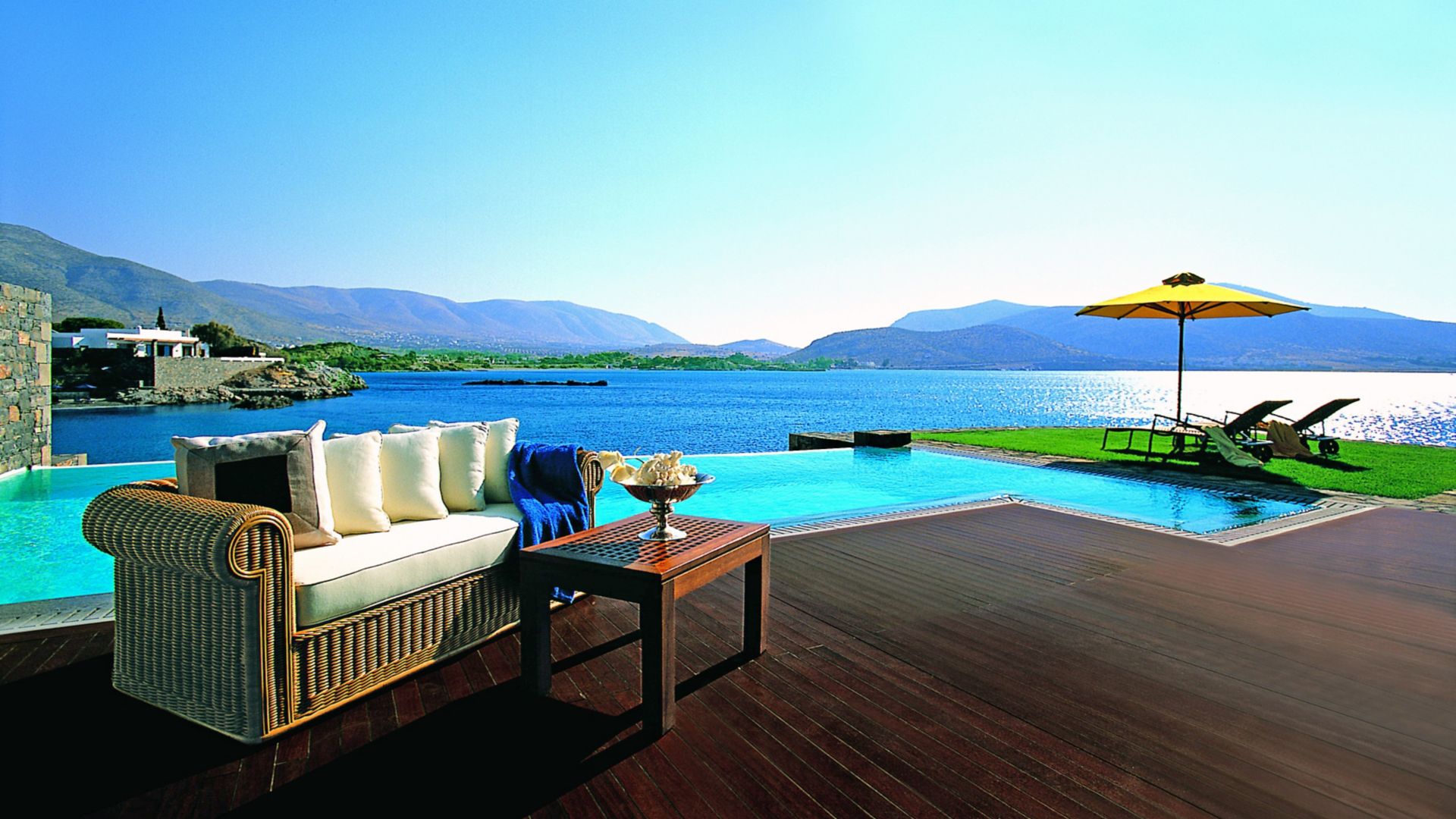 Wood floor installed by an infinity swimming pool	