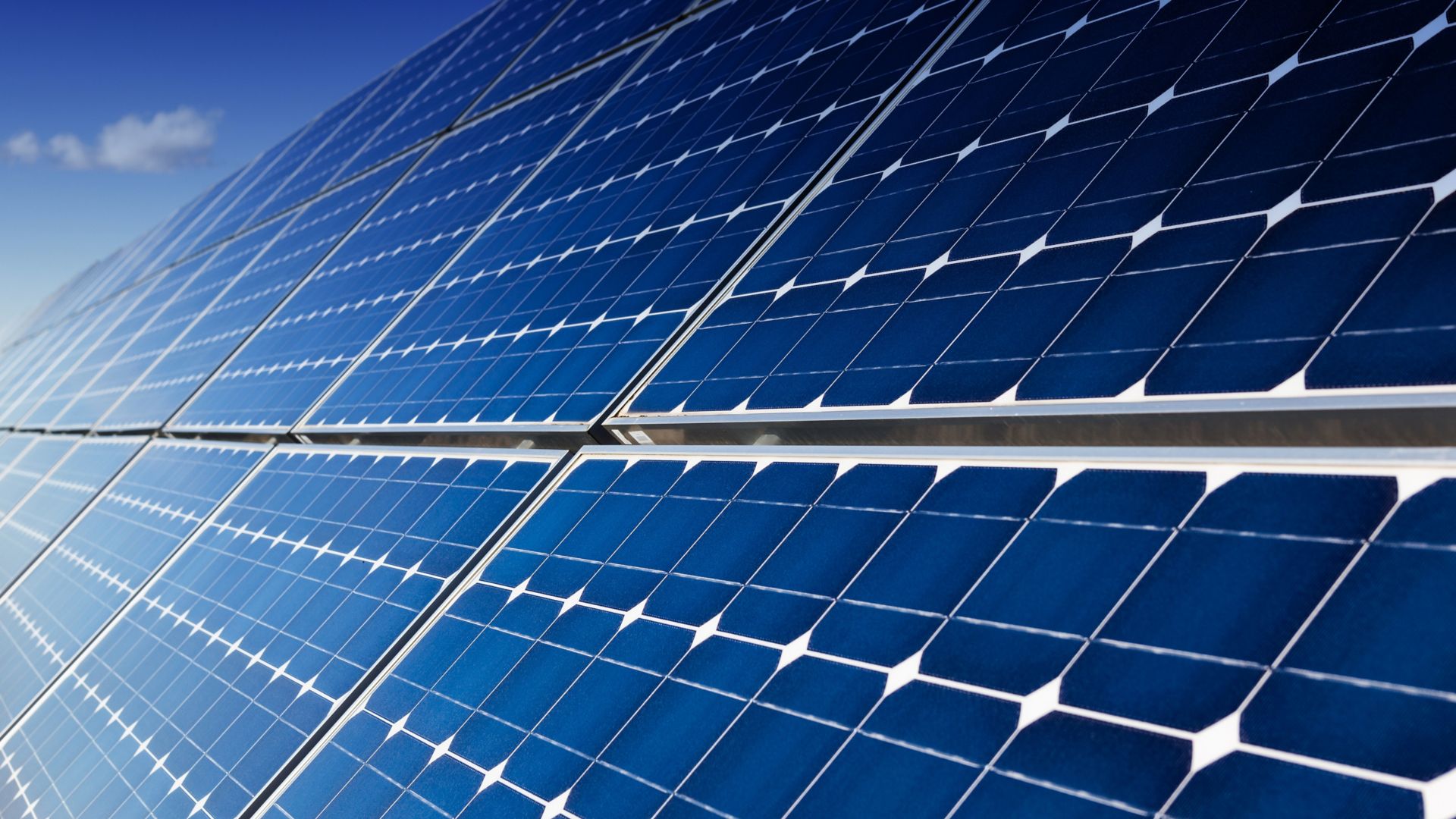 Photovoltaic solar panels installation and blue sky with few clouds