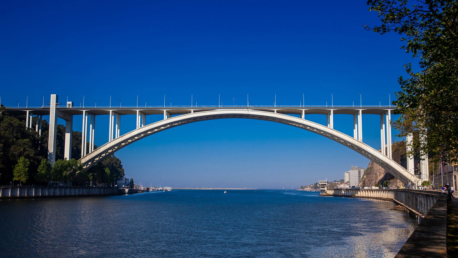 View of the Douro River mouth and the Arrabida Bridge in a beautiful early spring day at Porto City in Portugal