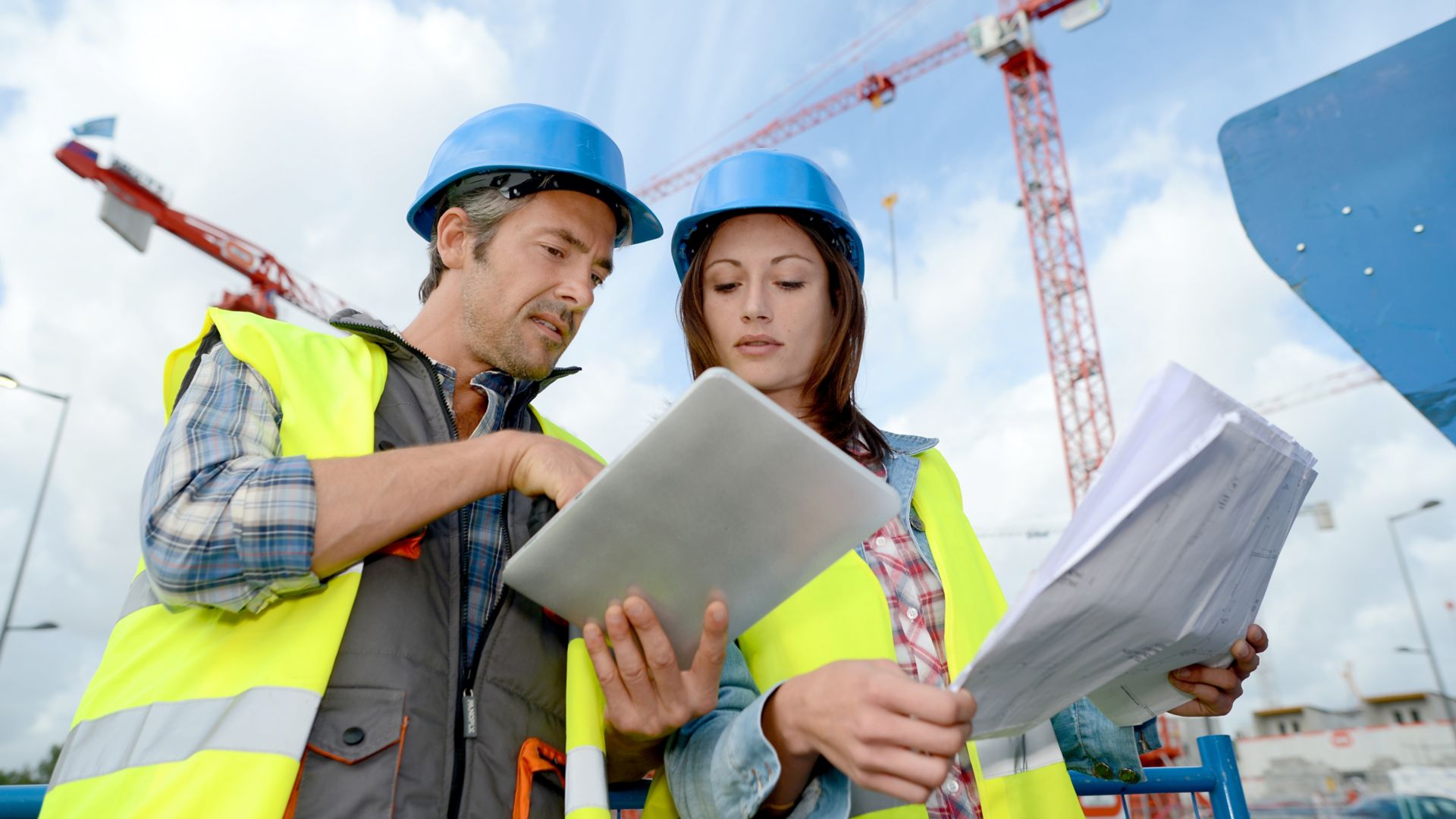 Construction manager and engineer working on building site