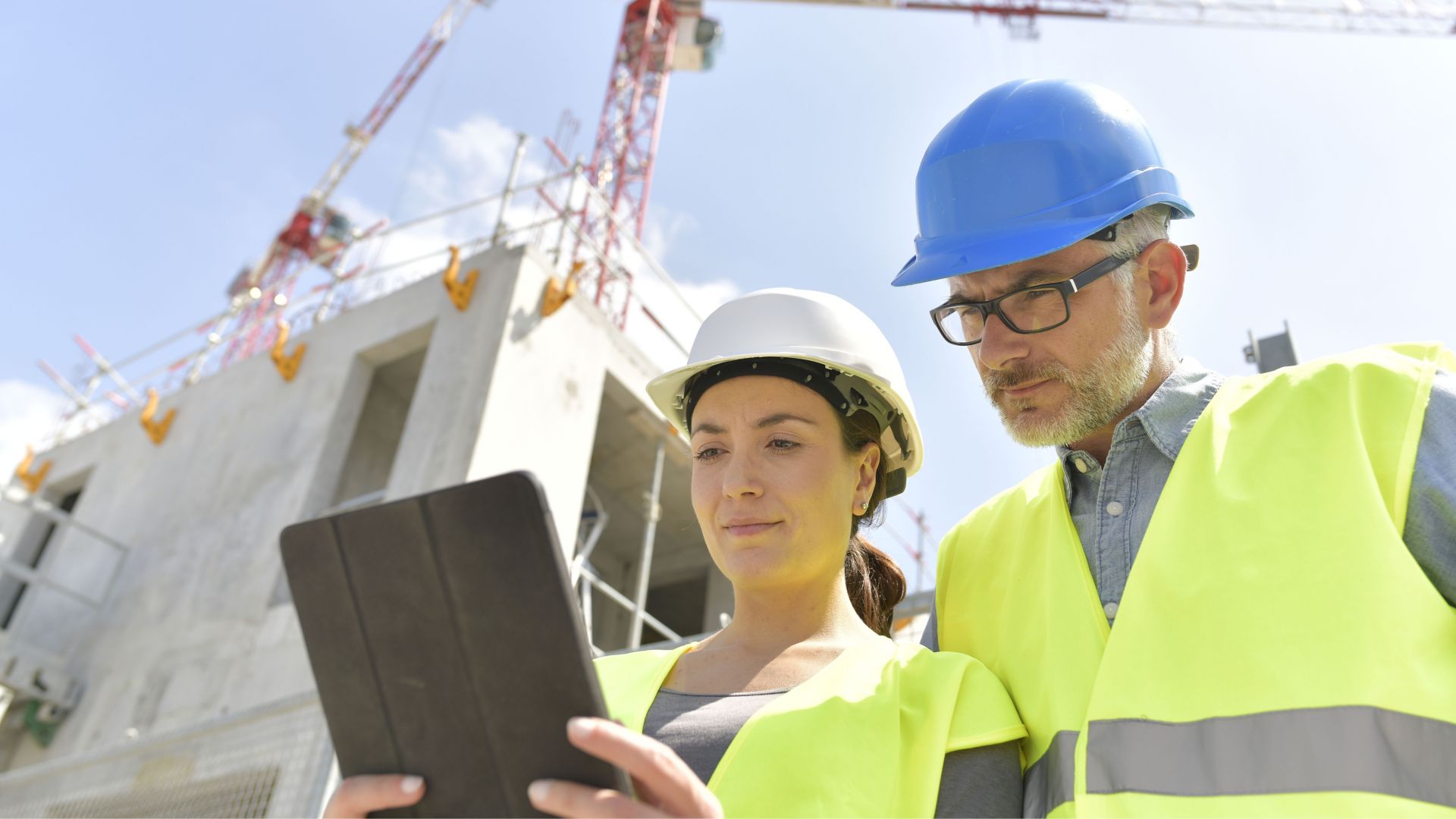 Construction manager and engineer working on building site