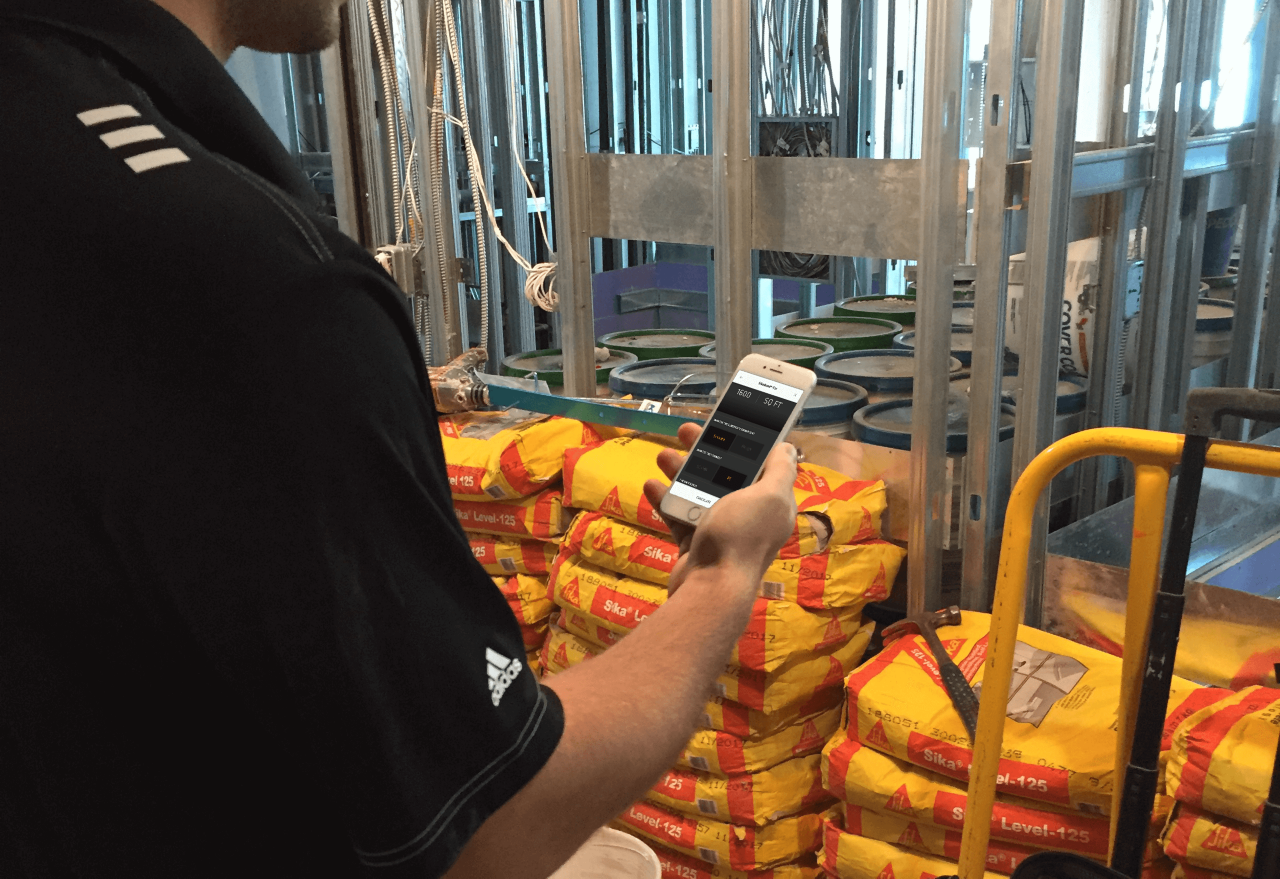 man holding an iPhone with the Sika Every Day mobile app installed