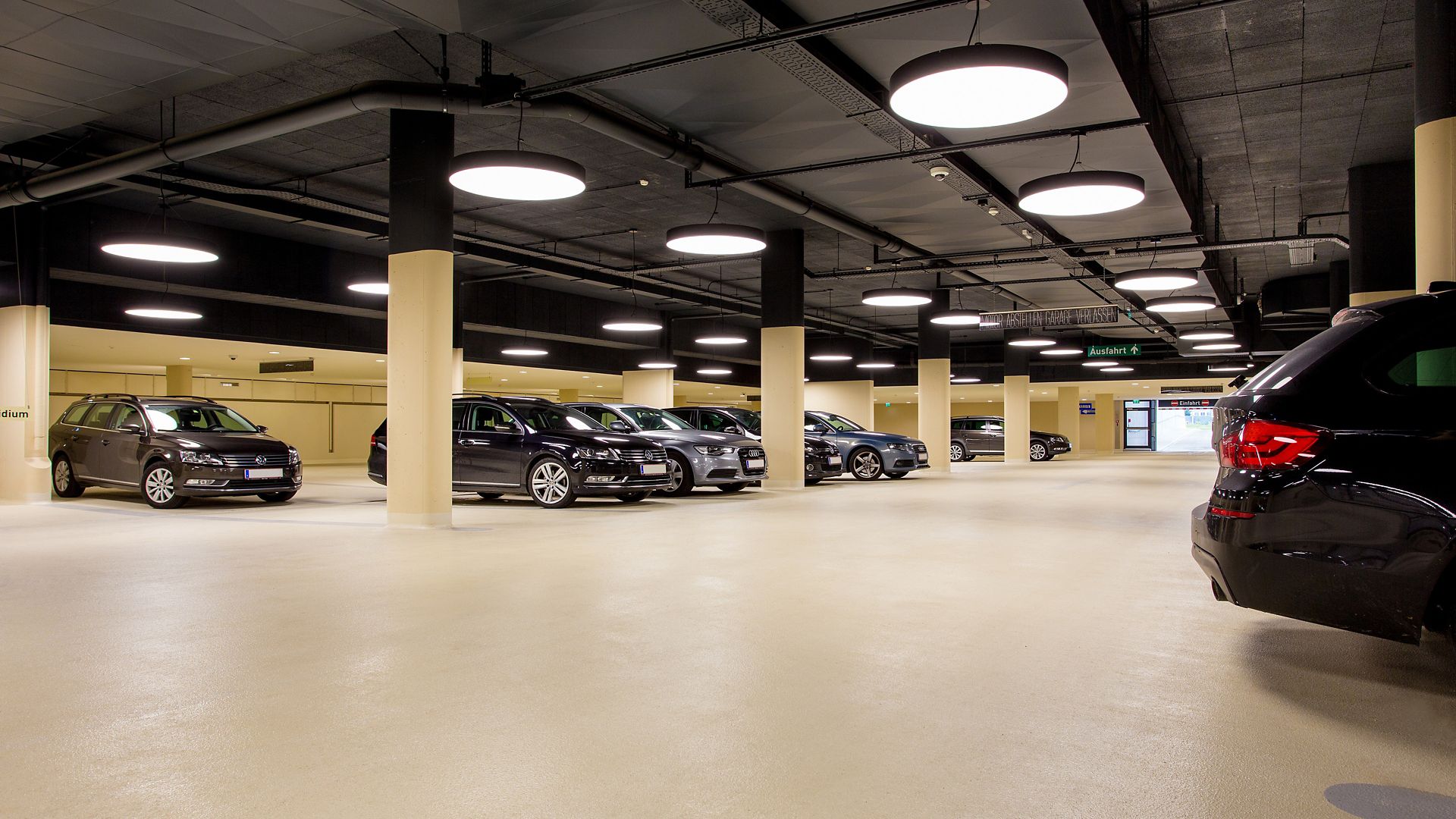 Cars in indoor parking garage made with Sikafloor coating system
