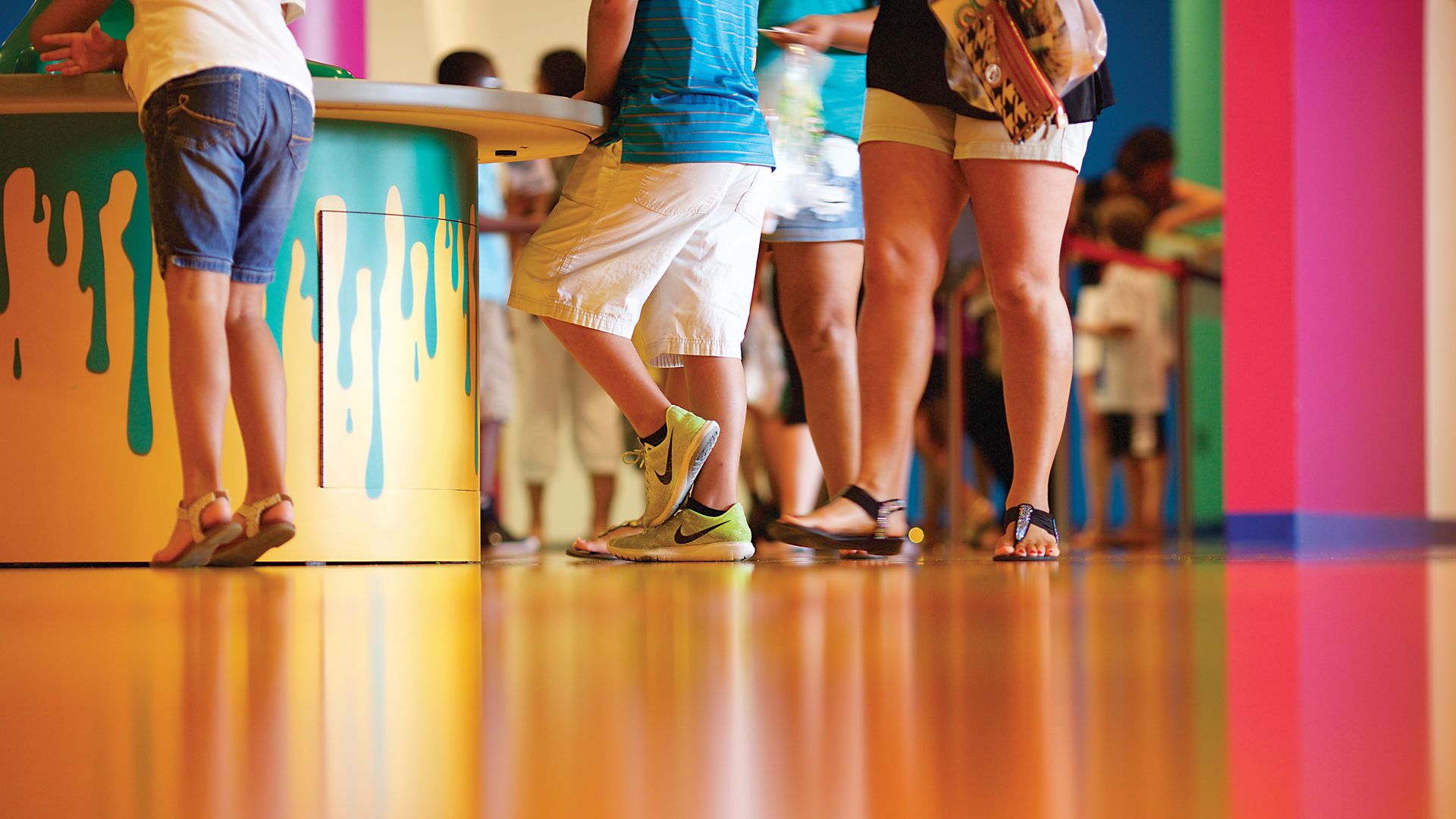 People standing on decorative orange floor made with Sika ComfortFloor system