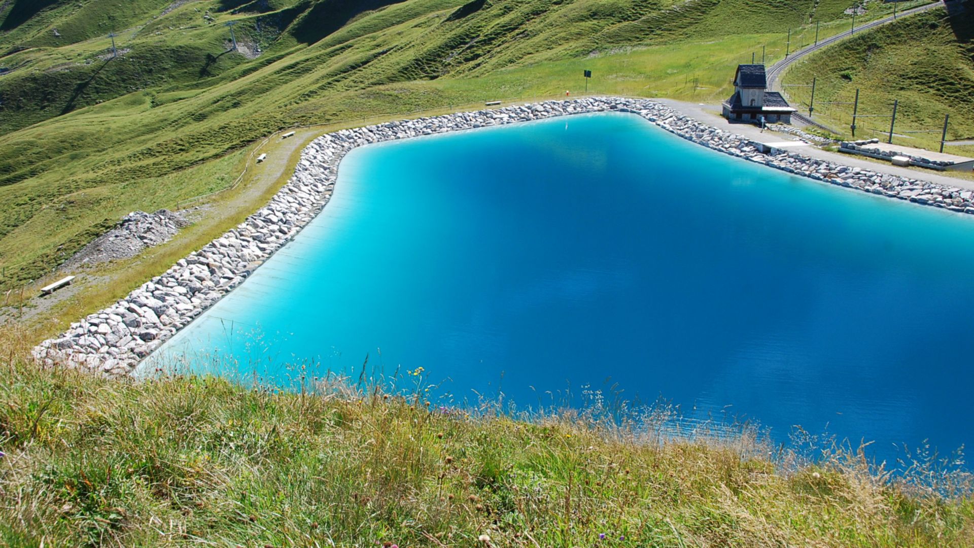 Retention pond in grassy mountains with potable water