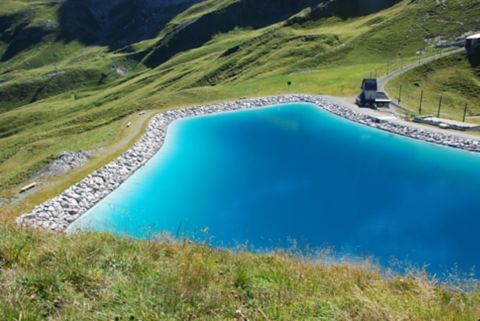 Retention pond in grassy mountains with potable water