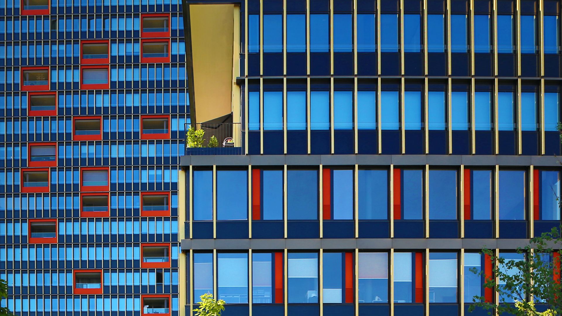 Highrise red and yellow facade with weather sealing glazing