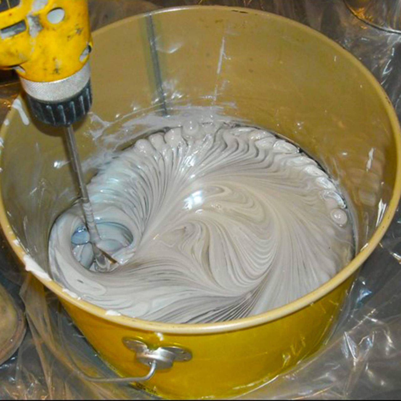 Yellow pail with Sika Epoxy being mixed