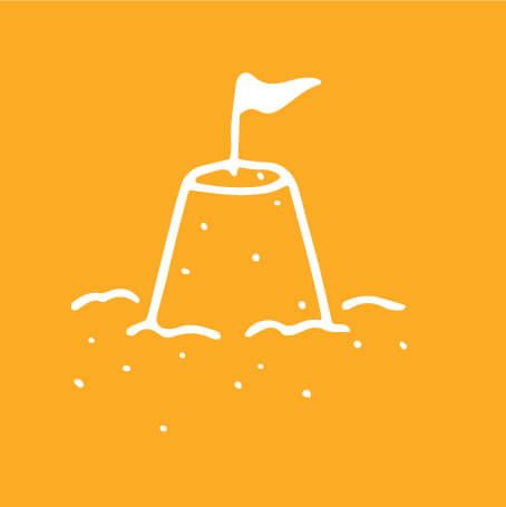 yellow and white graphic of sand castle with flag sticking out