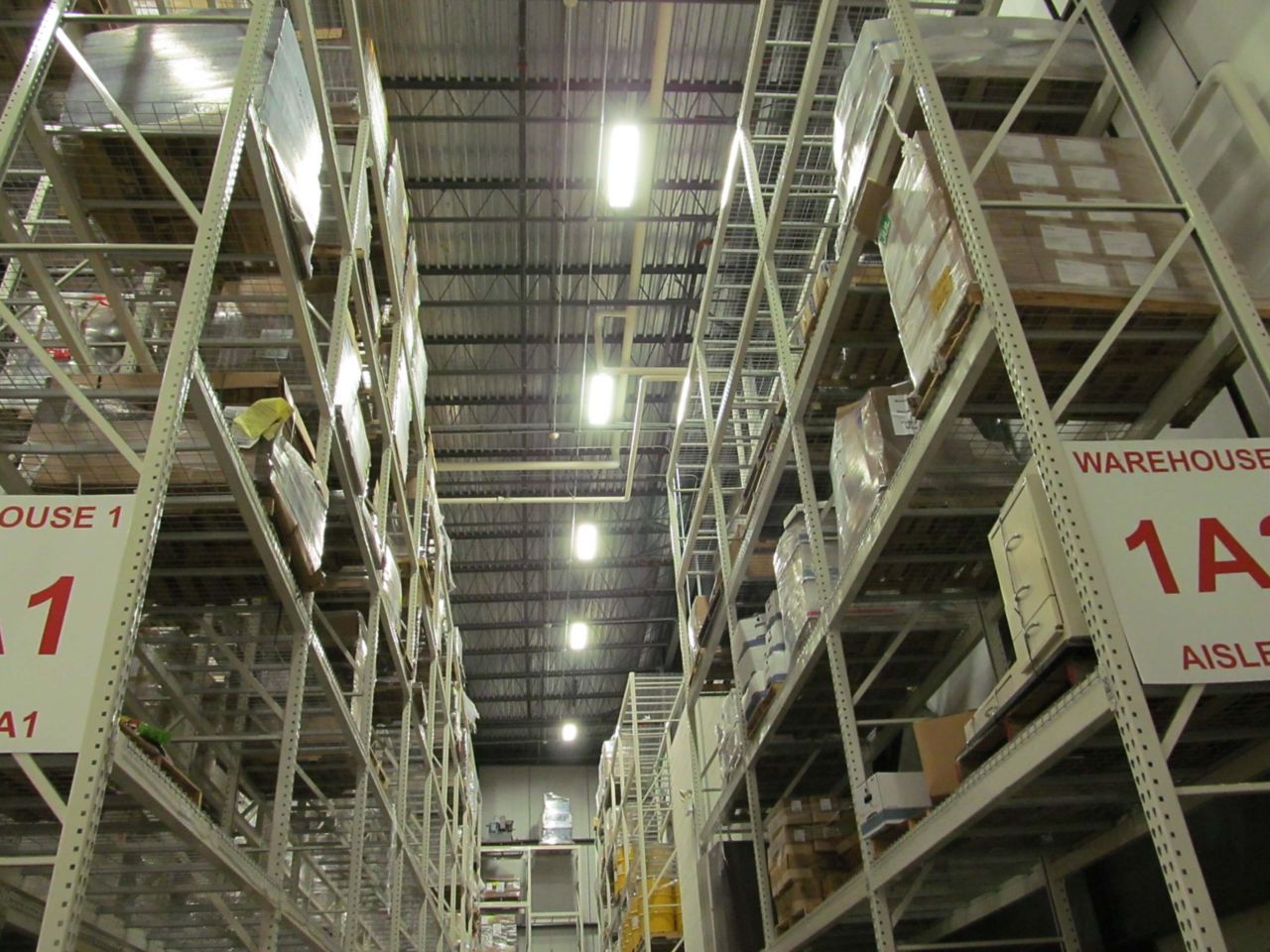Large metal warehouse shelves forming an isle in a warehouse