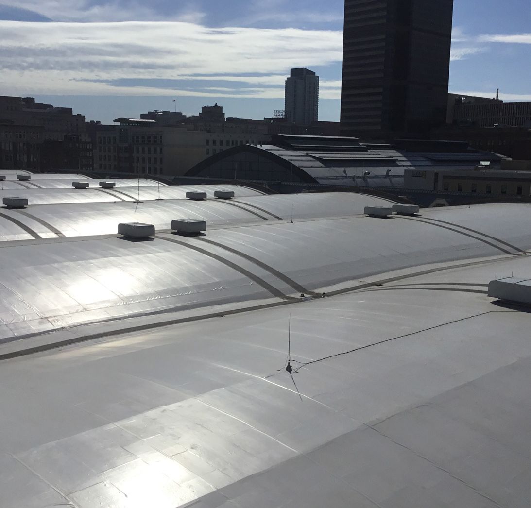 White membrane roof on top of the Pennsylvania convention center building with a skyline in the back