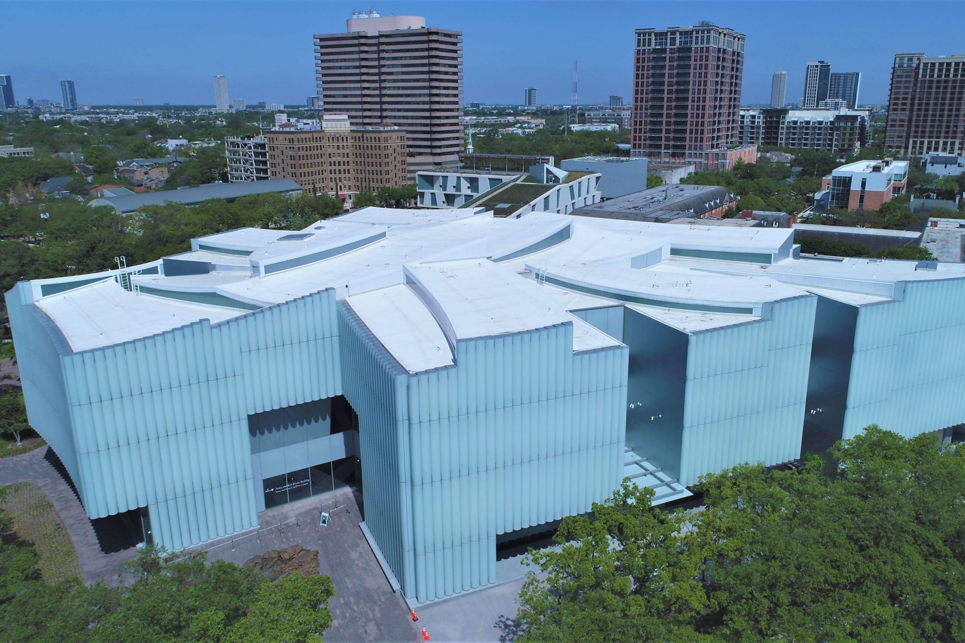 Aerial view of the Houston Museum of Fine Arts showing a white Sarnafil roofing membrane with a city skyline in the background.  