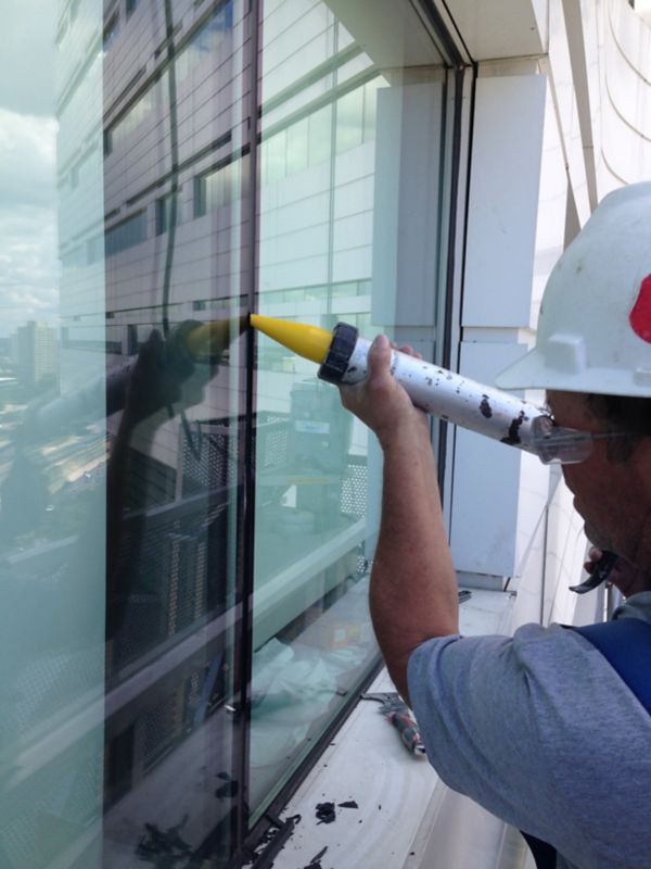 Silicone Joint Sealant Application to Exterior Window on Building