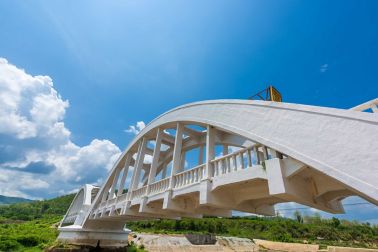 Old white railway bridge constructed against blue sky at Lamphun, Thailand.