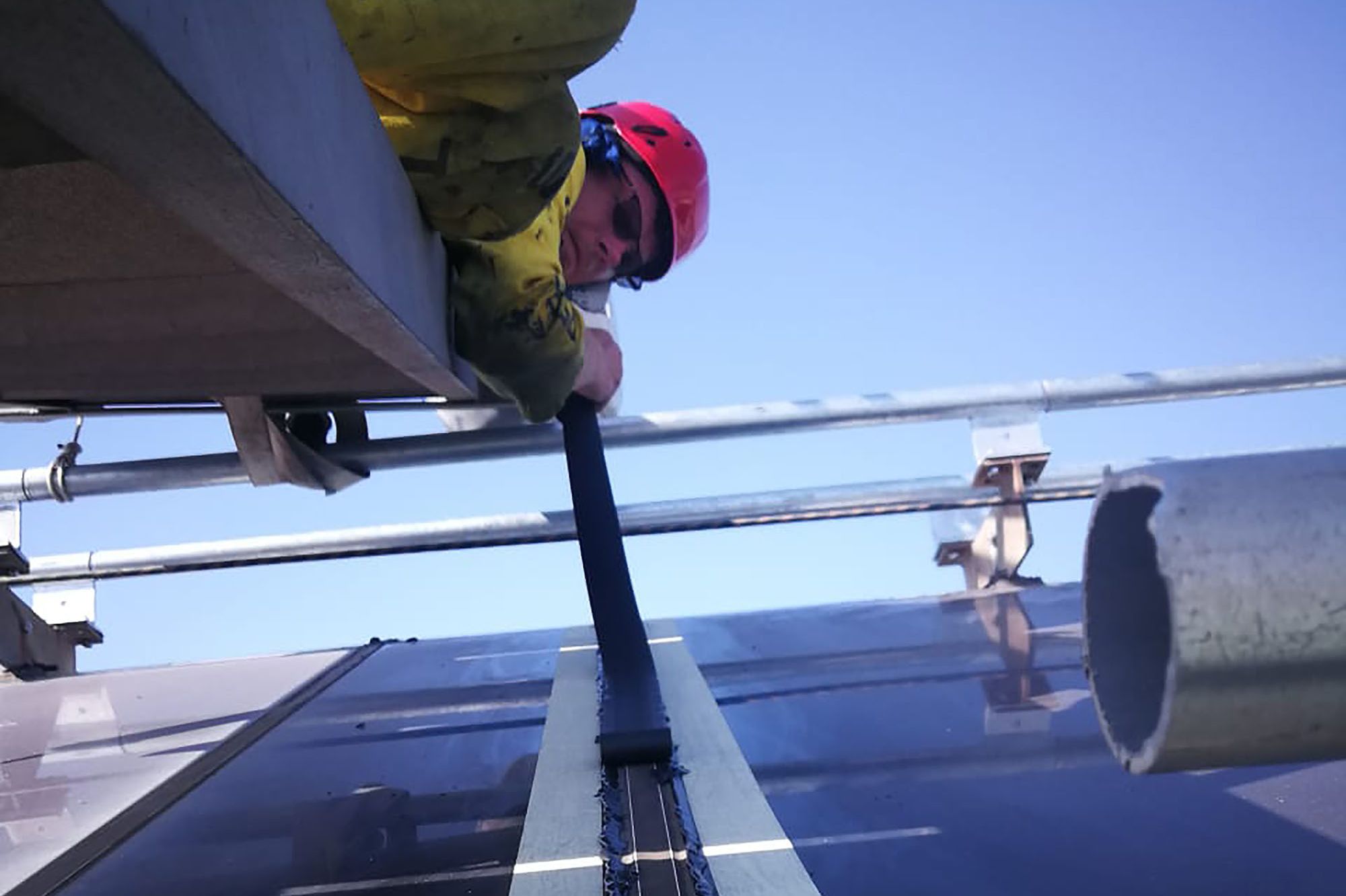 Man over-sealing the glazing joints of the skylights at Cape Town's V&A Waterfront