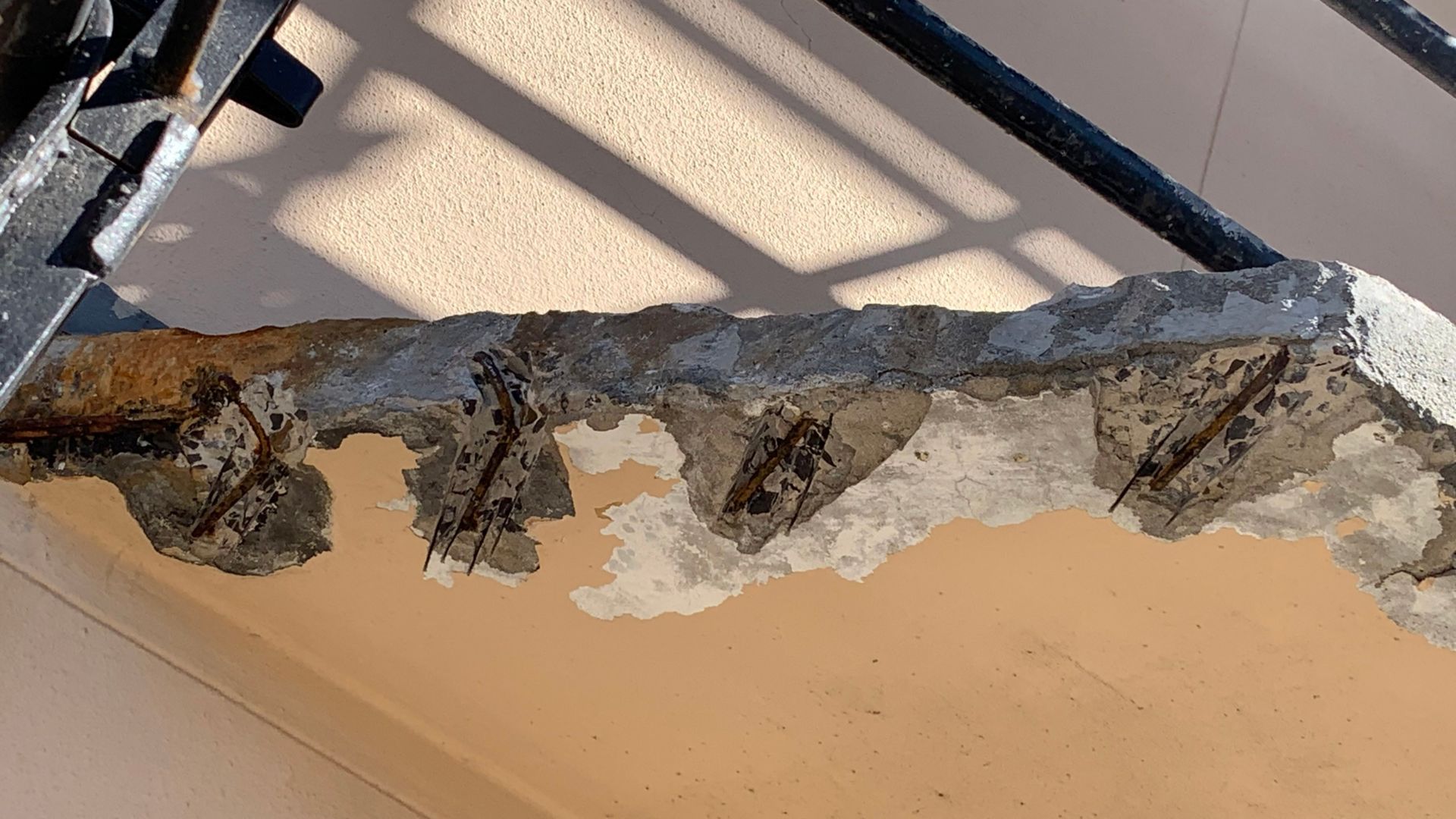 Corroding at residential flat, causing concrete to crack, push away and exposing the steel.
