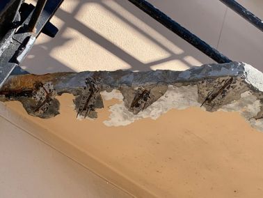 Corroding at residential flat, causing concrete to crack, push away and exposing the steel.