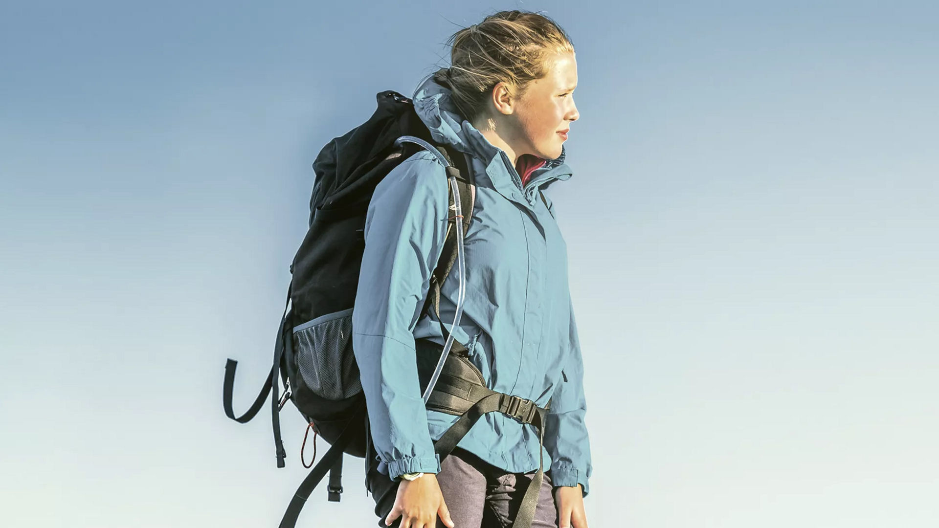 Hiker in blue jacket with backpack