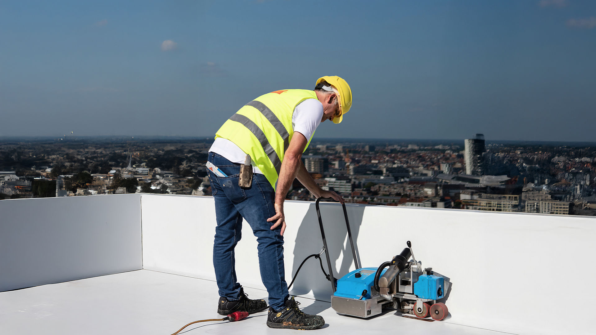 Construction worker laying waterproof membrane