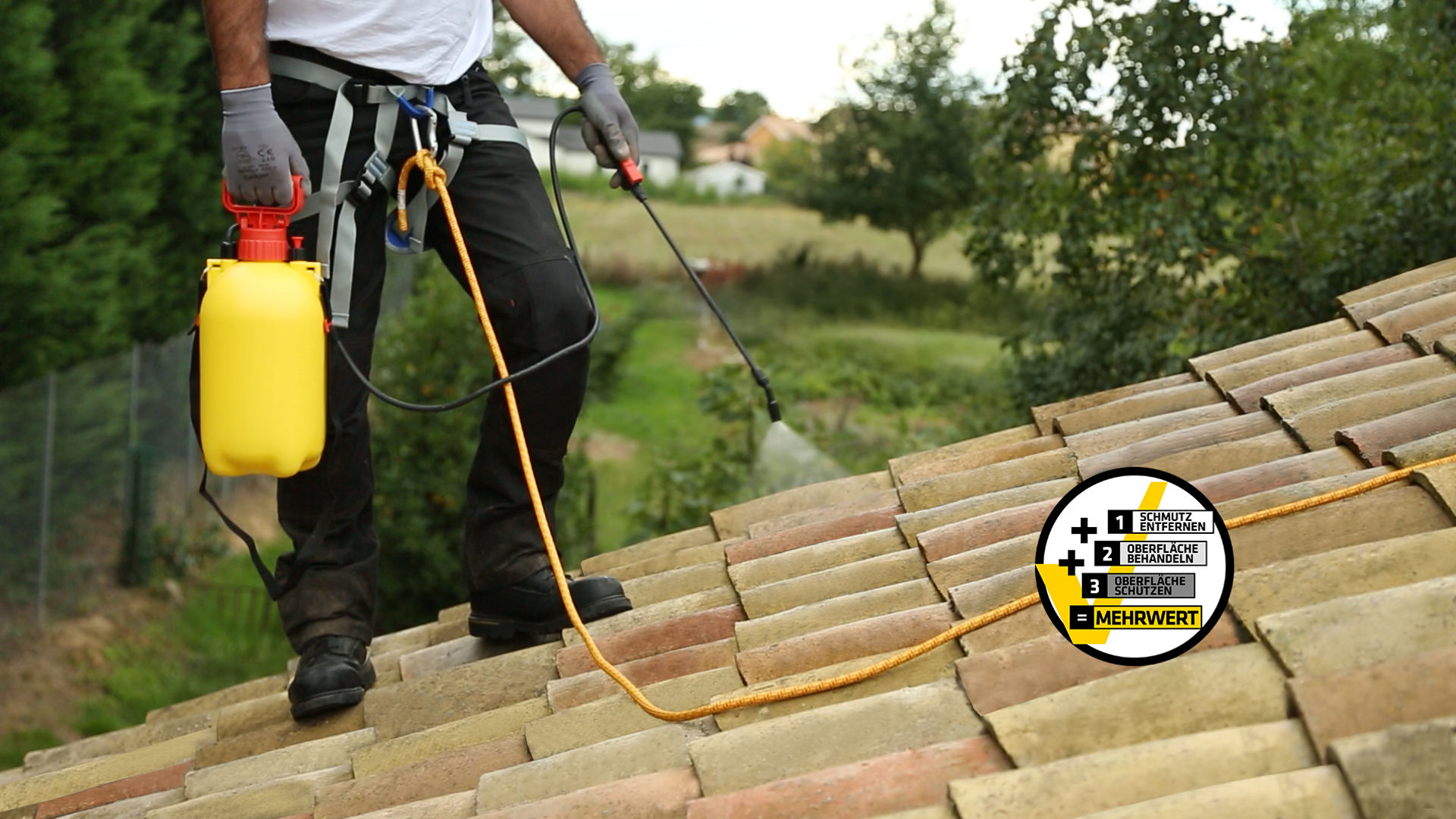 Worker spraying roof with yellow tank