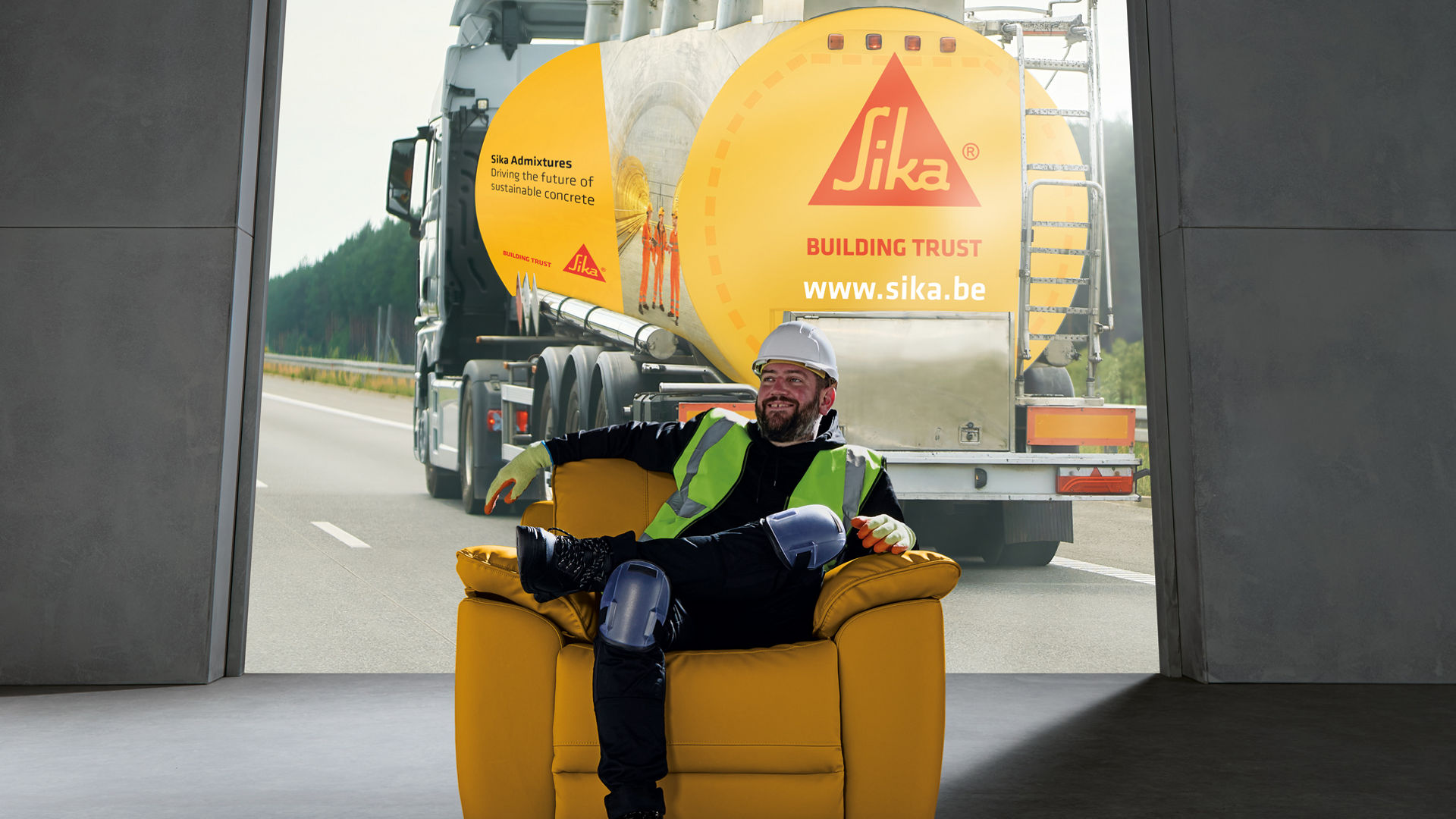 Worker in safety gear with Sika truck