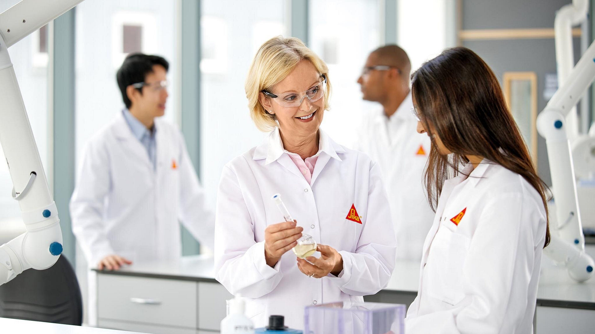Scientists collaborating in modern laboratory
