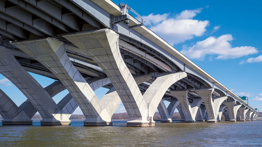 Modern concrete bridge over calm water