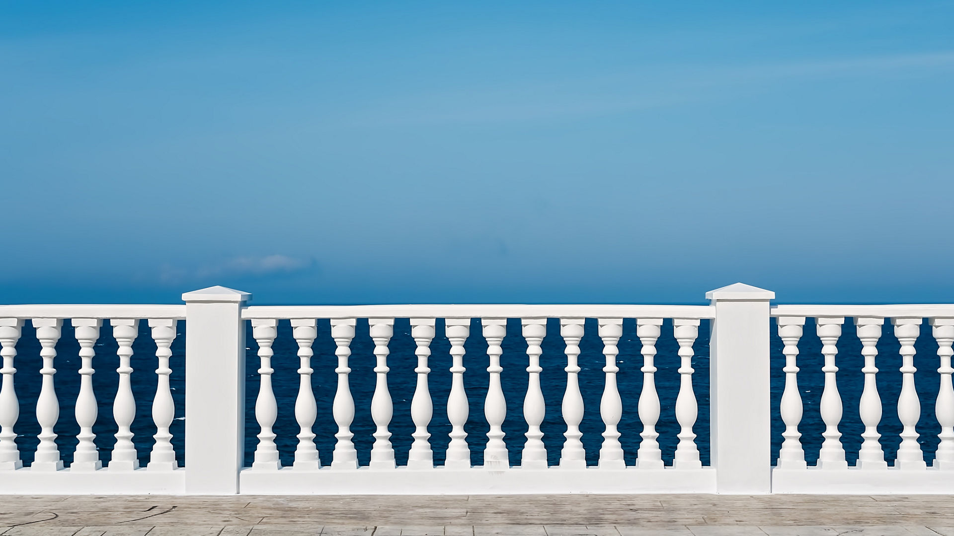 White balustrade overlooking blue ocean