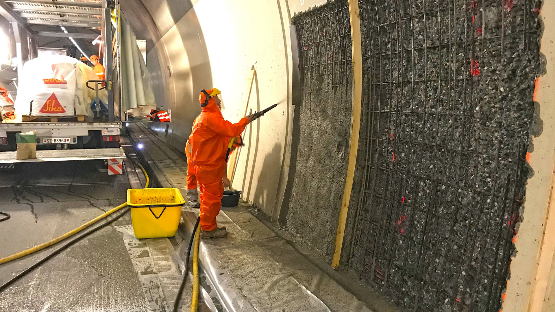 Orange dressed man spray covers the tunnel