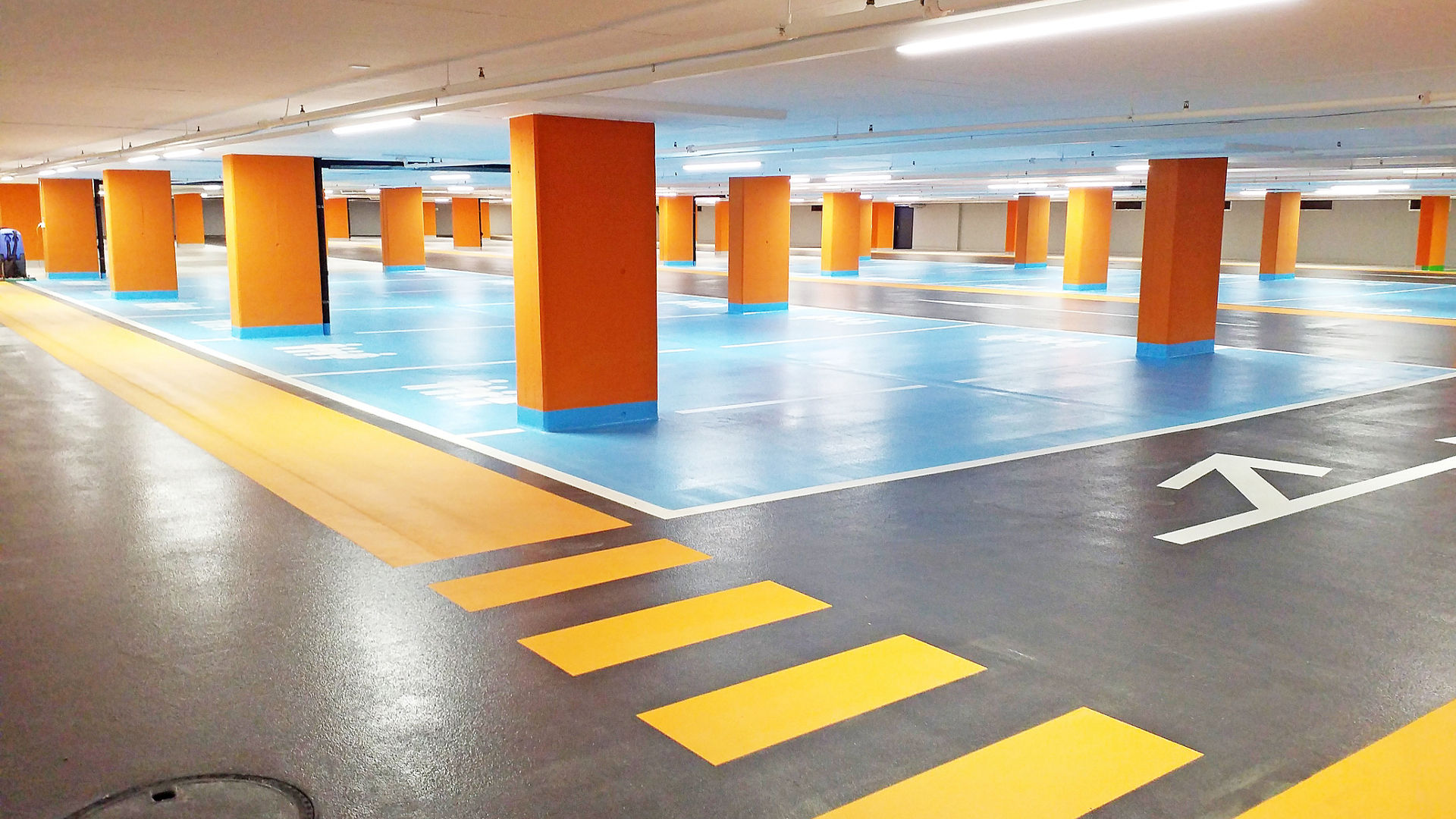 Seedam Center car parking garage floor with yellow, blue parking and orange columns