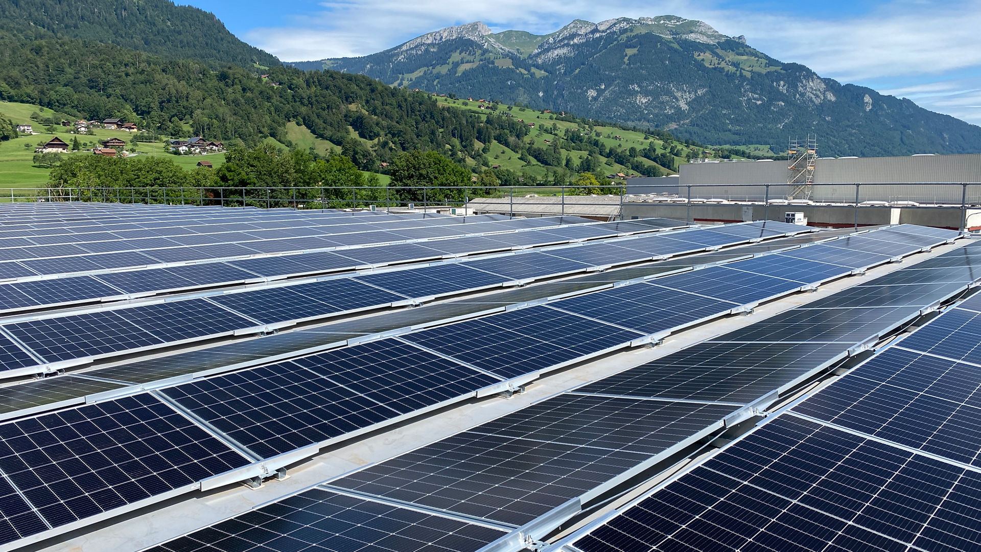 Sika solar mount system with PV panels on rooftop with mountains and blue sky