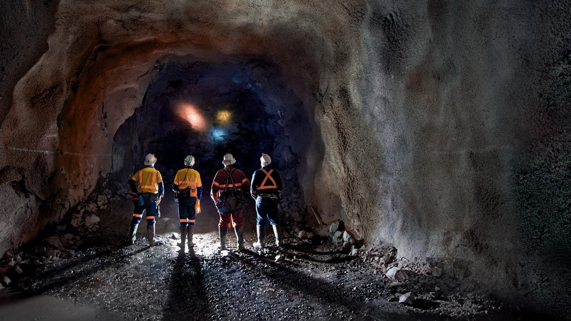 Workers standing in tunnel mining