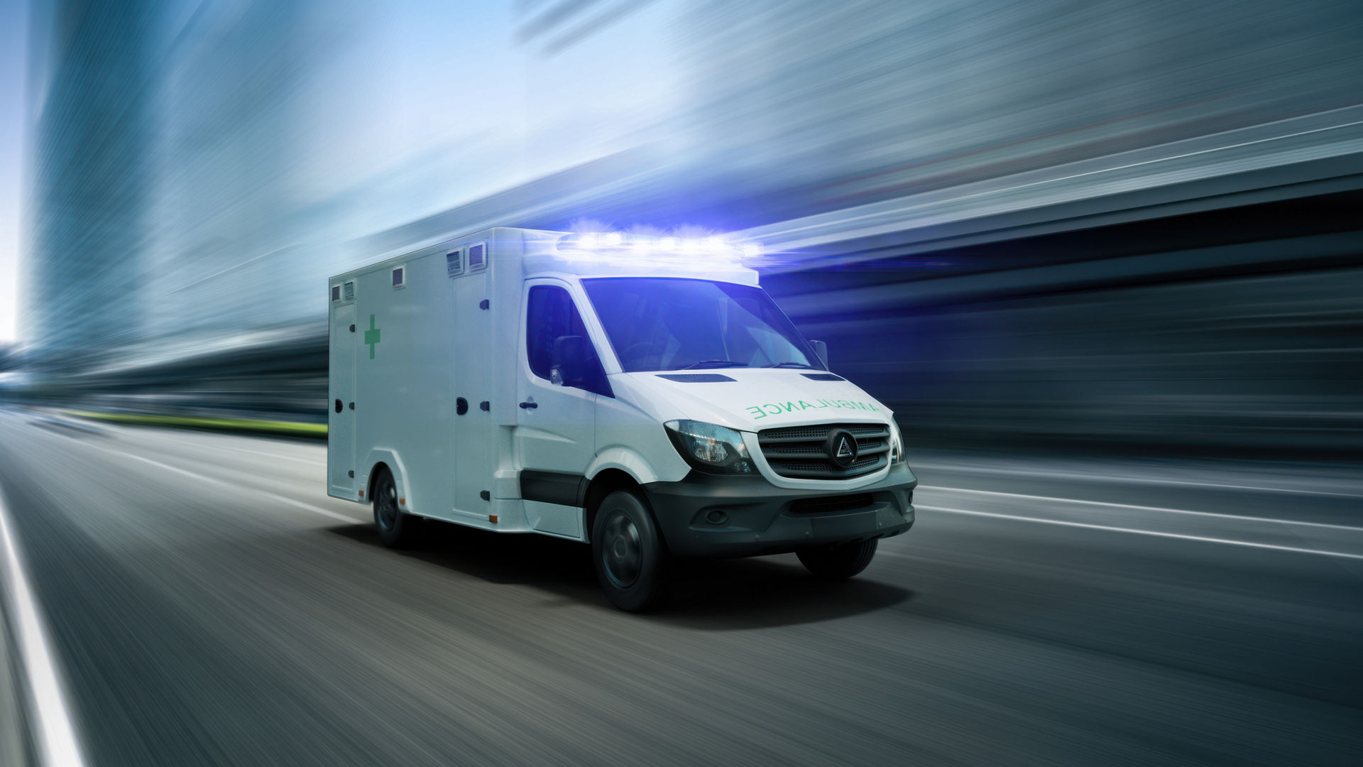 White ambulance speeding in urban setting