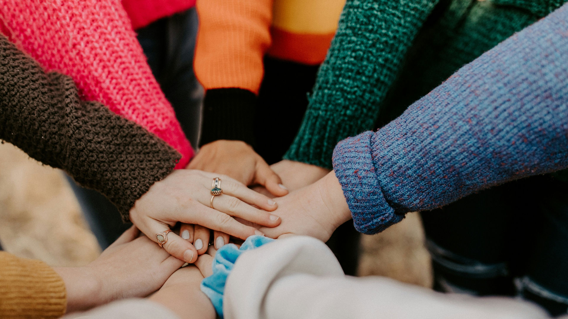 Group of People Joining Hands in Unity
