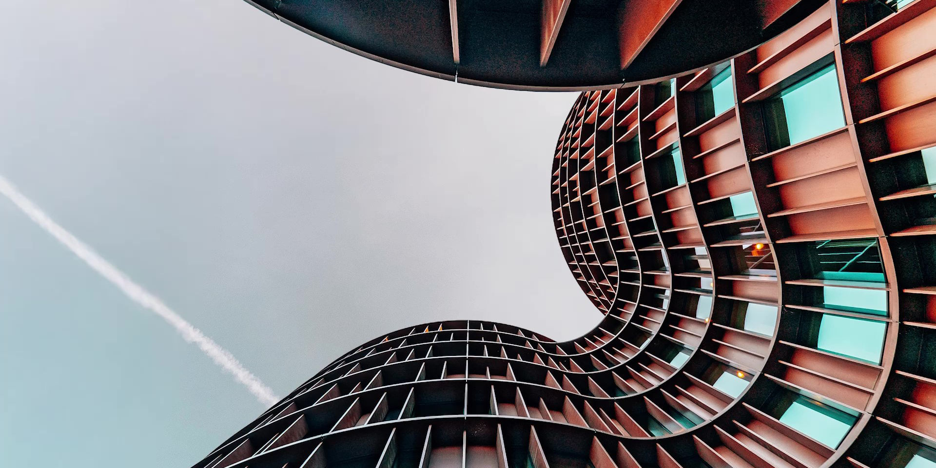 Curved Modern Building Against Clear Sky View